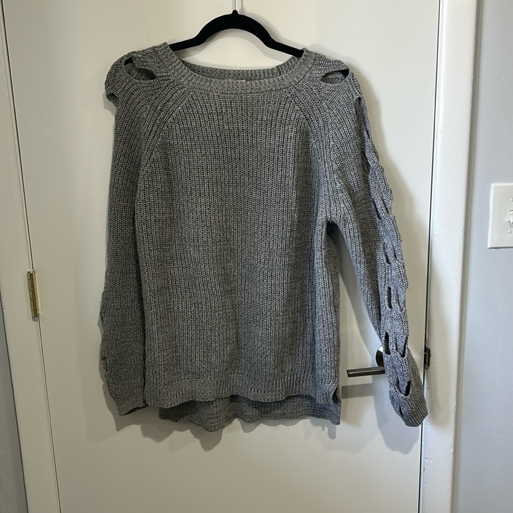 Grey sweater with open braided cutouts on sleeves